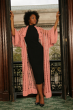 Sexy pretty woman wearing CharmaineLouise Intimates CLIntimates Diana pink cashmere crochet kimono robe black sheath dress